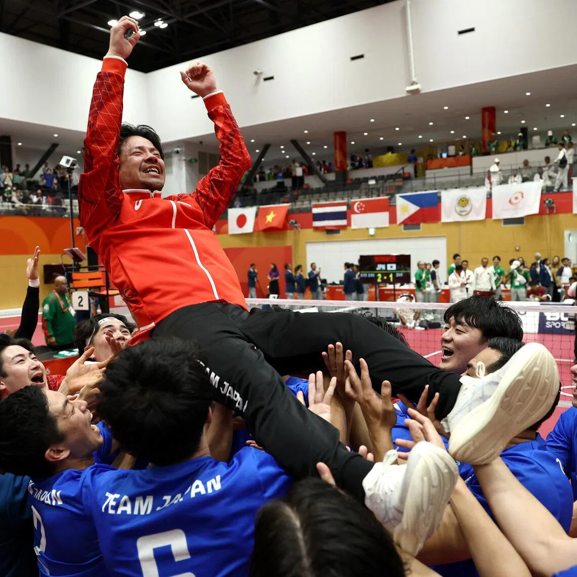 Japan’s head coach Takeshi Terashima is the toast of his team after they beat Indonesia to win the Asian Games men’s quadrant gold at Nagoya’s Paloma Mizuho Sports Park on Oct 3.