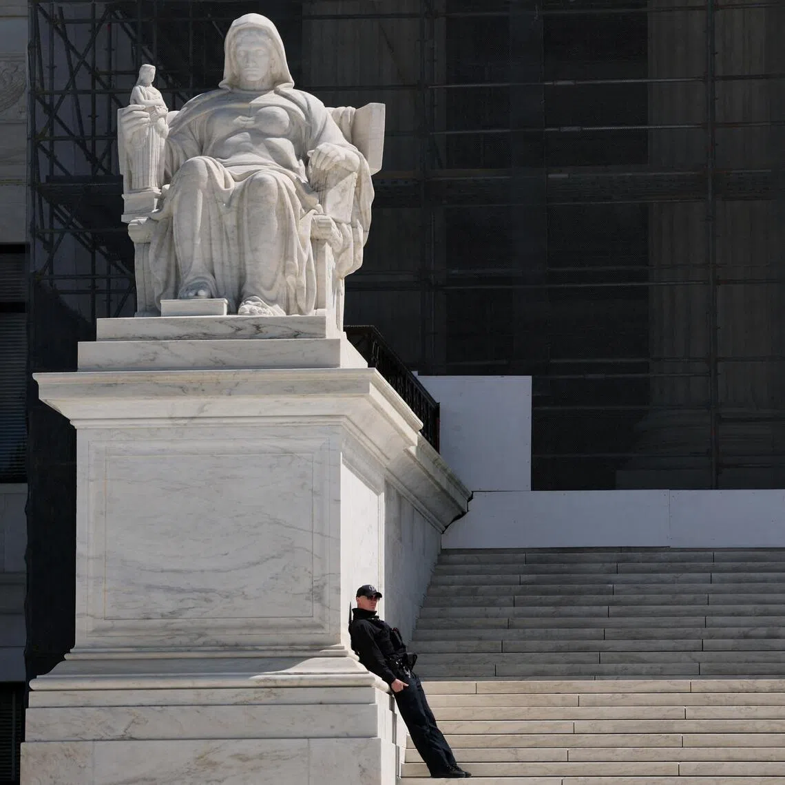 FILE PHOTO: A U.S. Supreme Court Police officer leans against the statue titled the Contemplation of Justice along the front steps of the U.S. Supreme Court building in Washington, D.C., U.S., April 8, 2025. REUTERS/Jonathan Ernst/File Photo