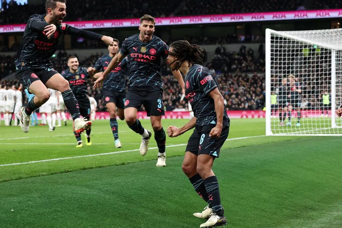 Soccer Football -  FA Cup - Fourth Round - Tottenham Hotspur v Manchester City - Tottenham Hotspur Stadium, London, Britain - January 26, 2024  Manchester City's Nathan Ake celebrates scoring their first goal with Bernardo Silva and Ruben Dias REUTERS/David Klein