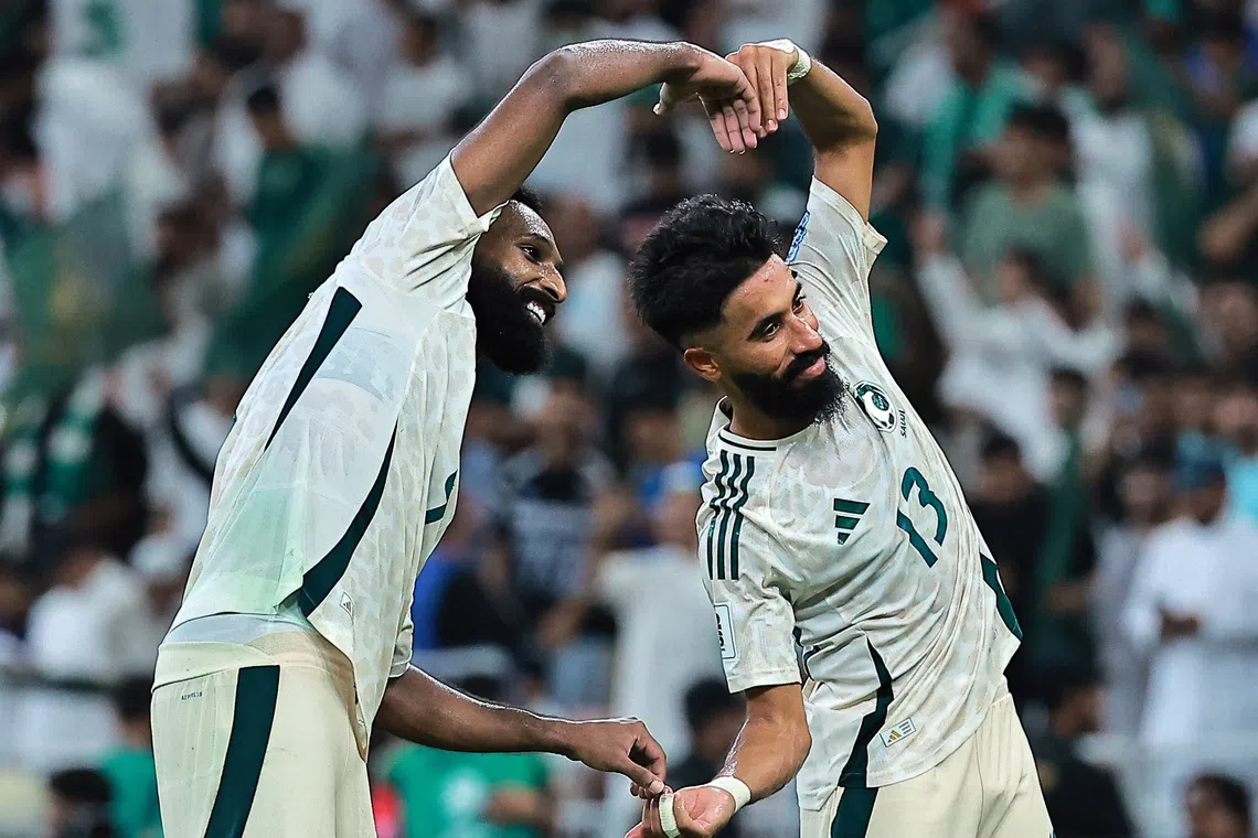 Saudi Arabia's Feras Al-Brikan (right) celebrates scoring their third goal with teammate Nawaf Boushal during the 3-2 win over Indonesia.