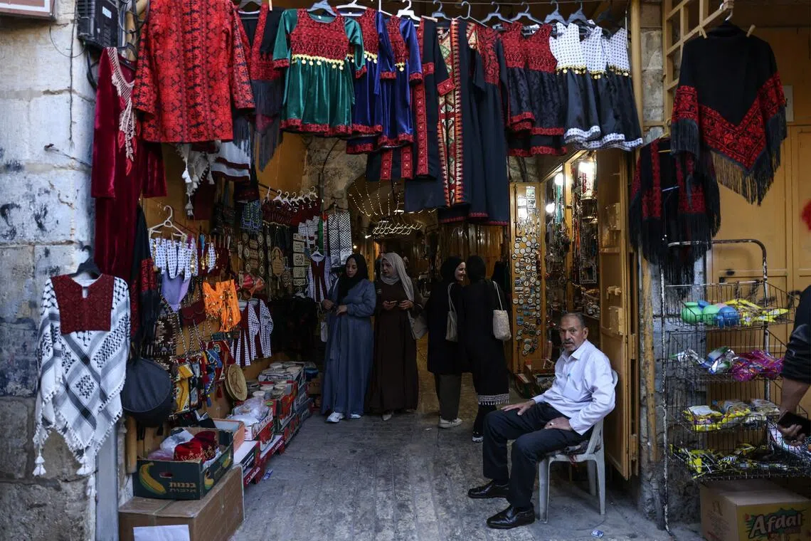 Palestinians walk through an alley in the Old City near the Ibrahimi Mosque in Hebron.