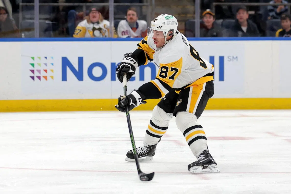 FILE PHOTO: Feb 3, 2026; Elmont, New York, USA; Pittsburgh Penguins center Sidney Crosby (87) shoots the puck against the New York Islanders during the first period at UBS Arena. Mandatory Credit: Brad Penner-Imagn Images/File Photo