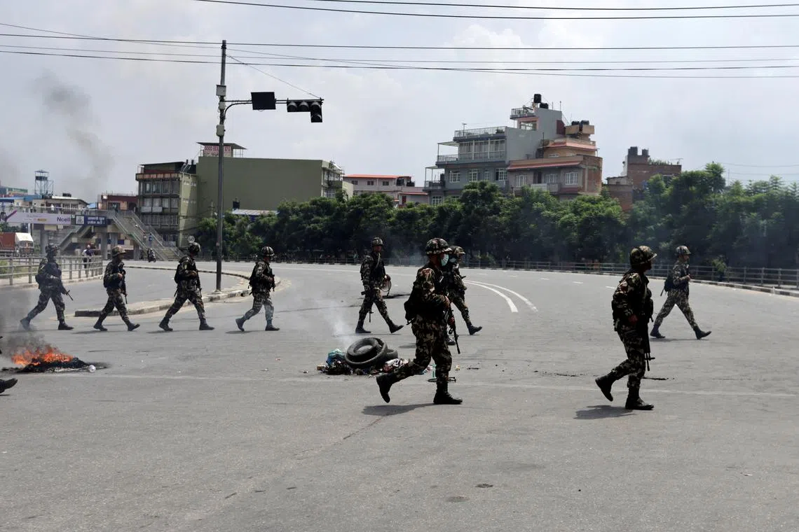 Nepal Army soldiers patrol a road during a curfew following anti-corruption protests that were triggered by a social media ban which was later lifted, in Kathmandu, Nepal, September 9, 2025. REUTERS/Navesh Chitrakar