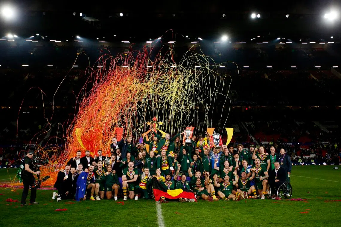 Rugby League - Men's World Cup Final - Australia v Samoa - Old Trafford, Manchester, Britain - November 19, 2022 Australia's men's and women's teams celebrate with their trophies after winning the world cup finals Action Images via Reuters/Ed Sykes