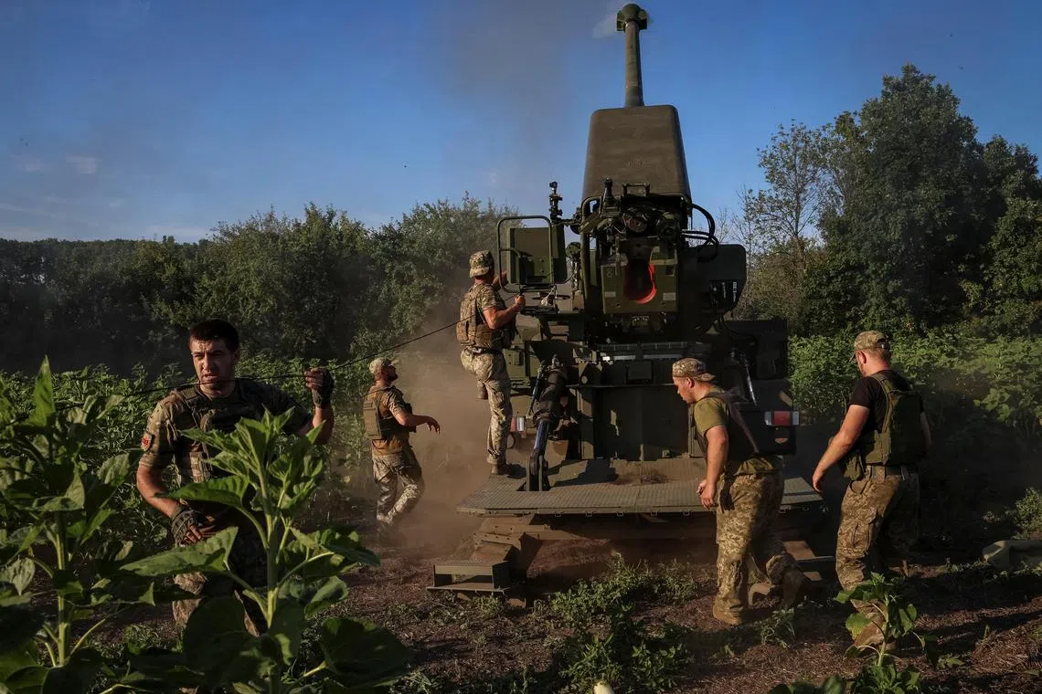 Ukrainian servicemen prepare to fire a howitzer towards Russian positions, at an undisclosed location in eastern Ukraine.