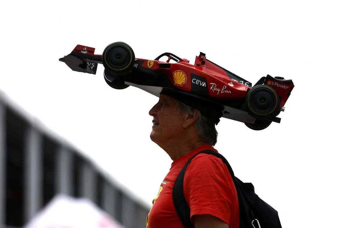 Formula One fan Kim Reimer posing for a photo with his homemade Ferrari hat ahead of the Canadian Grand Prix, June 15, 2023