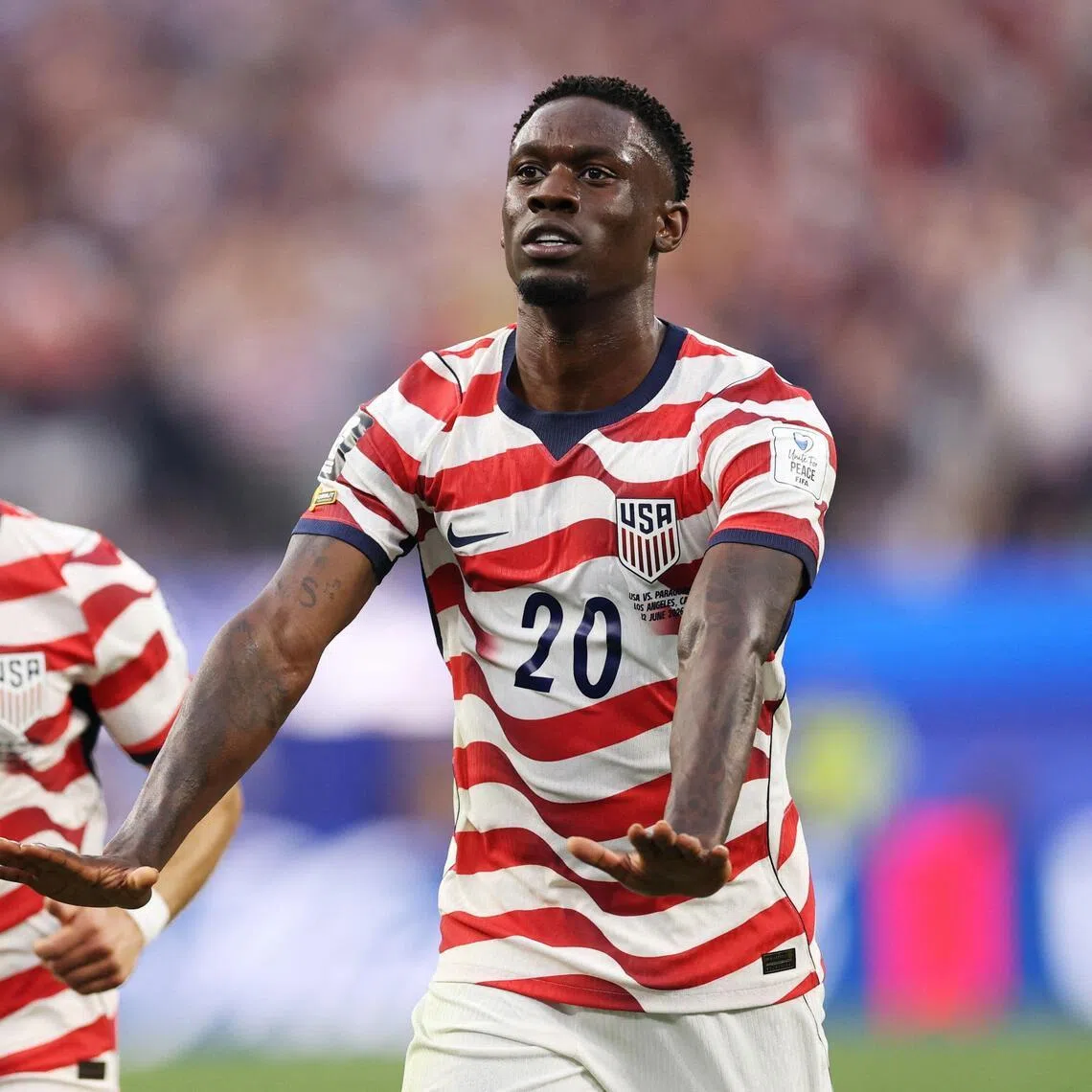 Folarin Balogun (right) of the United States celebrates scoring his team's third goal during the FIFA World Cup 2026 Group D match between USA and Paraguay at Los Angeles Stadium on June 12.
