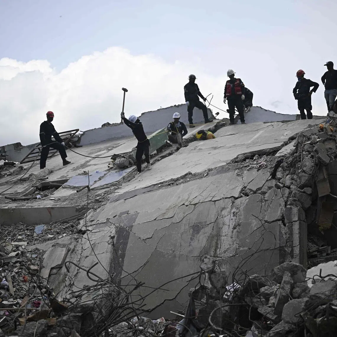 Firefighters and rescue workers operate amid the rubble of collapsed buildings in Catia La Mar, Venezuela, on July 8.