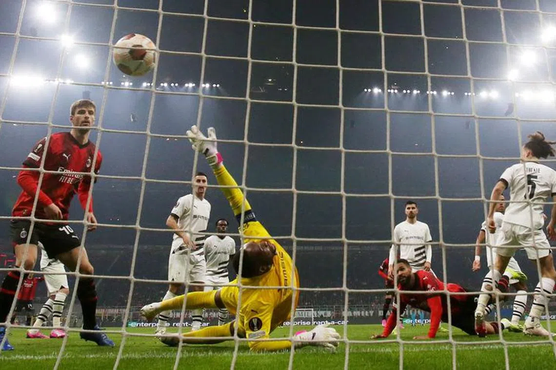 Soccer Football - Europa League - Play-Off - First Leg - AC Milan v Stade Rennes - San Siro, Milan, Italy - February 15, 2024 AC Milan's Ruben Loftus-Cheek scores their second goal past Stade Rennes' Steve Mandanda REUTERS/Claudia Greco