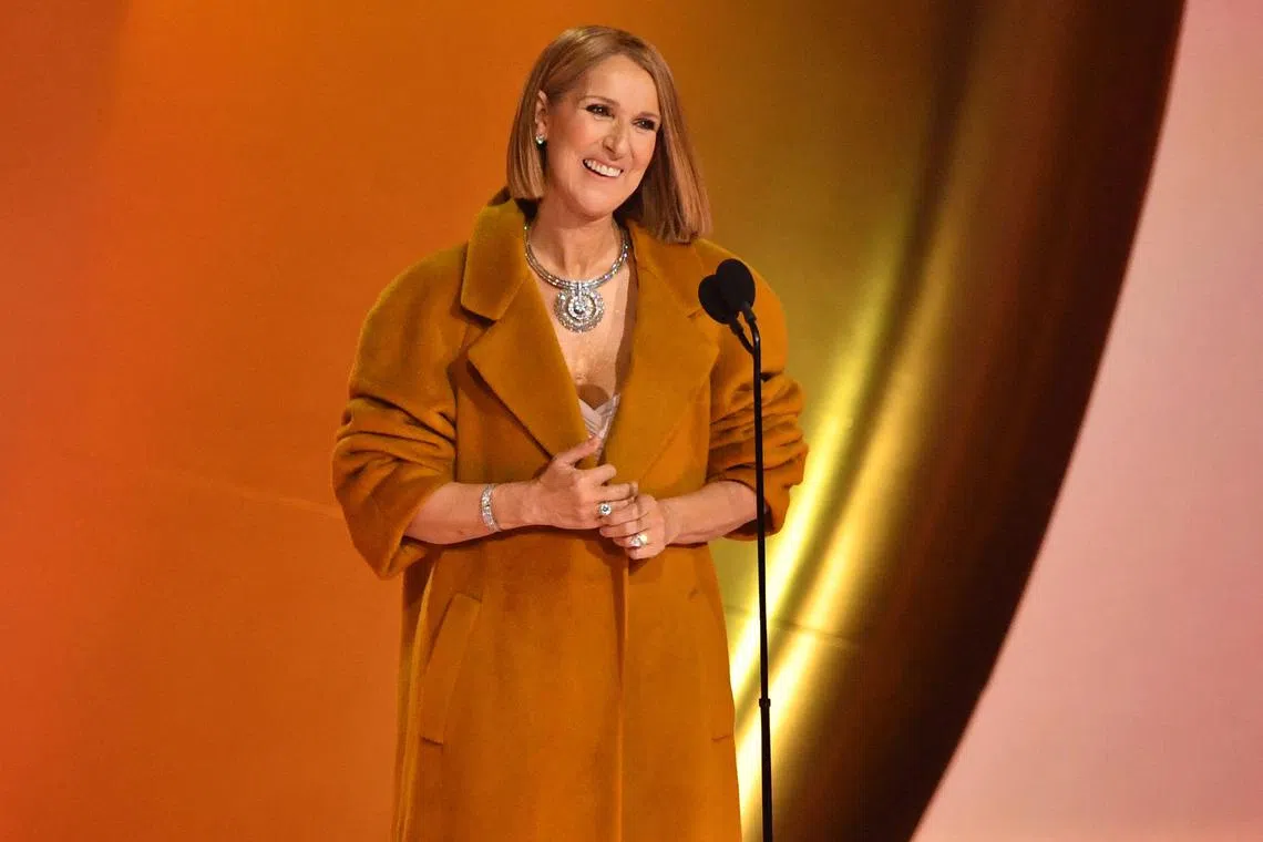 (FILES) Canadian singer Celine Dion presents the Album Of The Year award on stage during the 66th Annual Grammy Awards at the Crypto.com Arena in Los Angeles on February 4, 2024. Pop megastar Celine Dion, who is suffering from a rare neurological disorder, said in an Instagram post she looks forward to her return to the stage and her fans. Dion, 55, first disclosed in December 2022 that she had been diagnosed with Stiff Person Syndrome, which causes stiff muscles in the torso, arms and legs, with noise or emotional distress known to trigger spasms. (Photo by Valerie Macon / AFP)