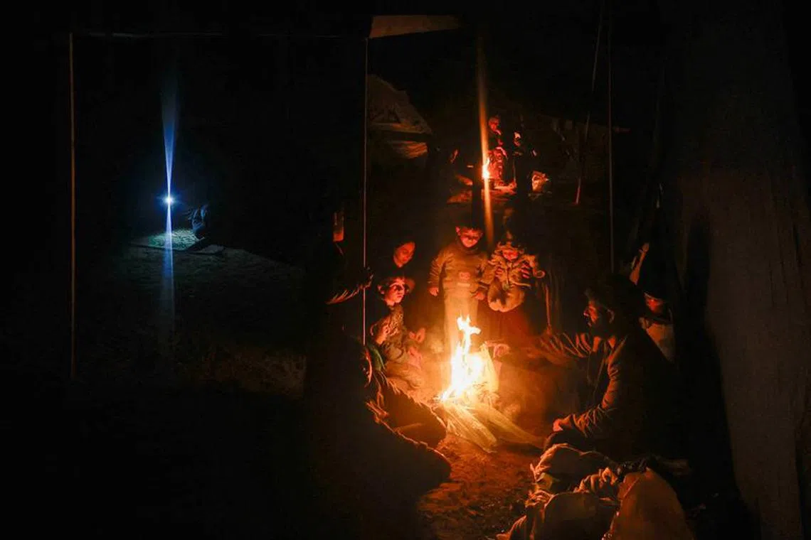 Palestinians who fled their houses due to Israeli strikes shelter in a tent, amid the ongoing conflict between Israel and the Palestinian Islamist group Hamas, in Rafah, in the southern Gaza Strip, January 1, 2024. REUTERS/Mohammed Salem