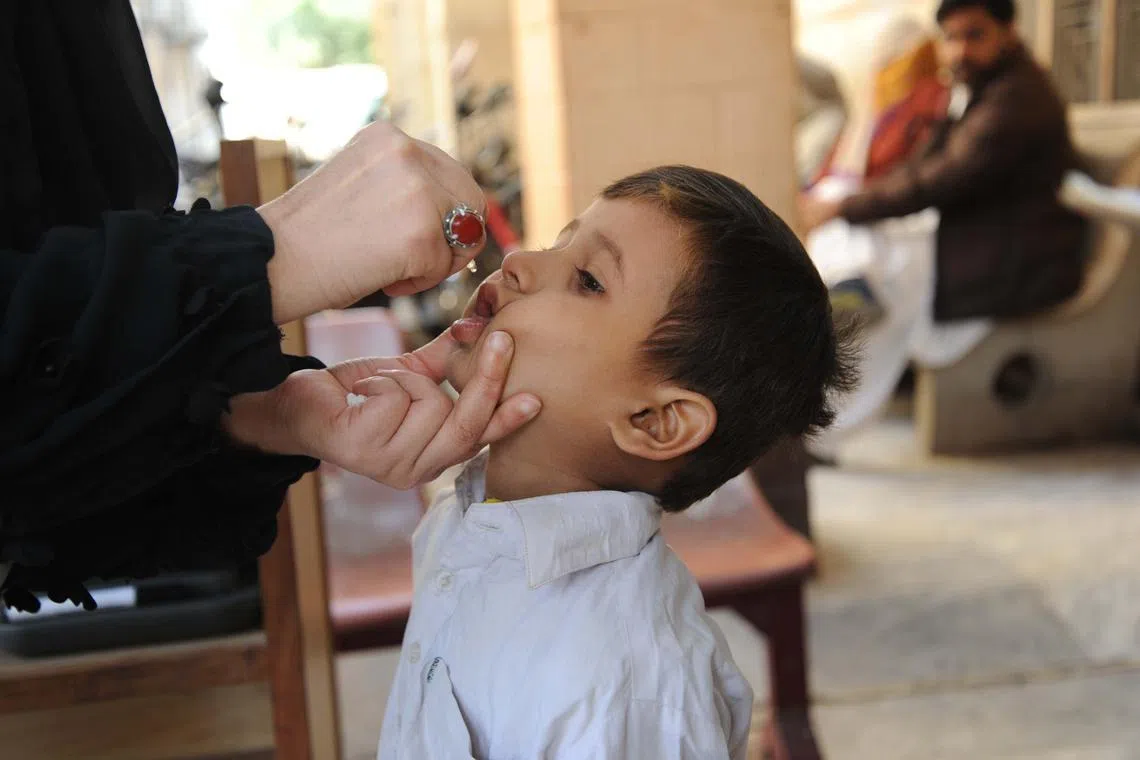 A boy receiving a dose of polio vaccine in Hyderabad, Pakistan. There is no cure for polio, but it can be prevented by being vaccinated against the disease.
