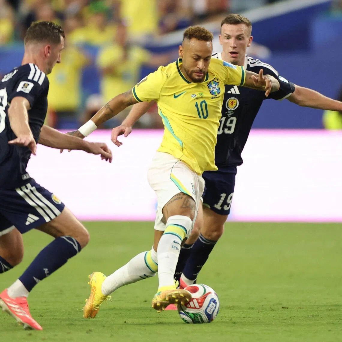 TOPSHOT - Brazil's forward #10 Neymar, Scotland's midfielders #23 Kenny McLean and #19 Lewis Ferguson fight for the ball during the 2026 World Cup Group C football match between Scotland and Brazil at the Miami Stadium in Miami Gardens on June 24, 2026.  (Photo by PATRICIA DE MELO MOREIRA / AFP)
