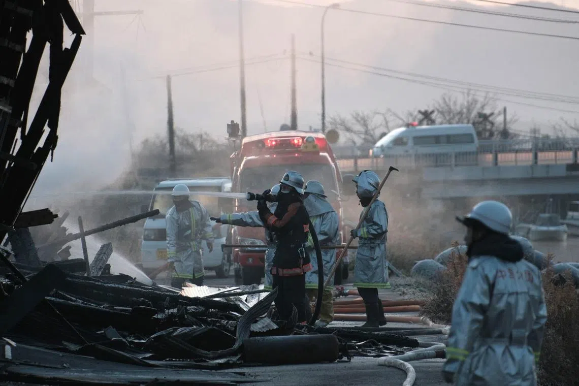 Firefighters extinguish a fire in Nanao, Ishikawa Prefecture, Japan on Jan 2, 2024. 