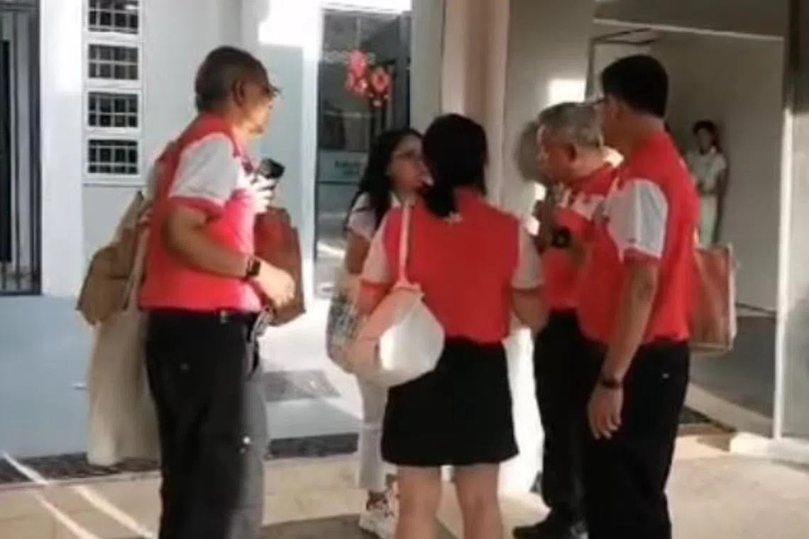 One of the videos released by Mr Azman Ibrahim shows a group of PSP members standing in a circle speaking to an unidentified female PAP volunteer.