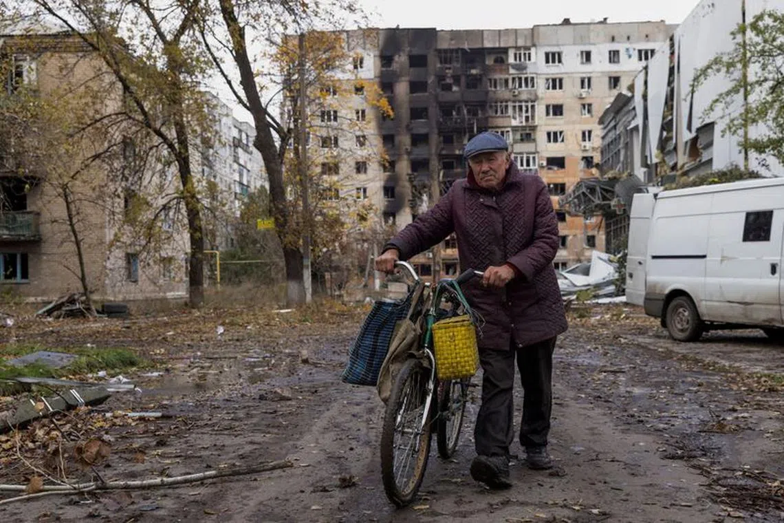 FILE PHOTO: A local resident walks in front of damaged residential buildings, amid Russia's attack on Ukraine, in the town of Avdiivka, Donetsk region, Ukraine October 17, 2023. REUTERS/Yevhen Titov/File Photo