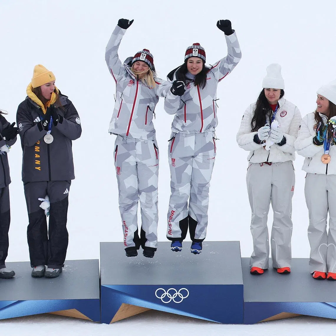 Milano Cortina 2026 Olympics - Alpine Skiing - Women's Team Combined Victory Ceremony - Tofane Alpine Skiing Centre, Belluno, Italy - February 10, 2026. Gold medallists Ariane Raedler of Austria and Katharina Huber of Austria celebrate on the podium after winning the Women's Team Combined with silver medallists Kira Weidle-Winkelmann of Germany and Emma Aicher of Germany and bronze medallists Jacqueline Wiles of United States and Paula Moltzan of United States REUTERS/Leonhard Foeger