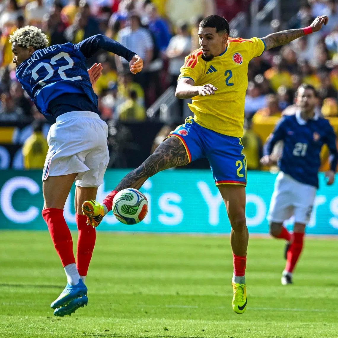 Mar 29, 2026; Landover, Maryland, USA;  Columbia defender Daniel Mu–oz (2) plays the ball past France forward Hugo Ekitike (22) during the second half at Northwest Stadium. Mandatory Credit: Tommy Gilligan-Imagn Images