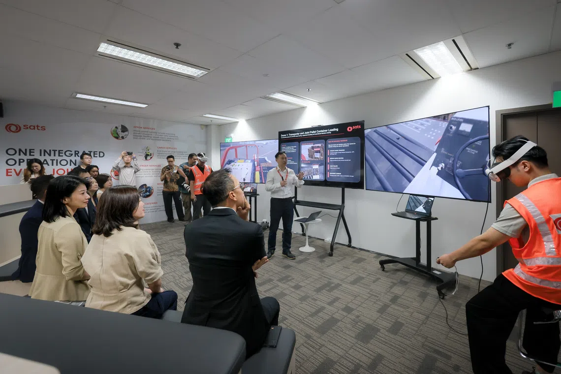 Senior Minister of State for Transport Sun Xueling (seated, third from right) at the launch of the SATS Immersive Centre on Oct 15.