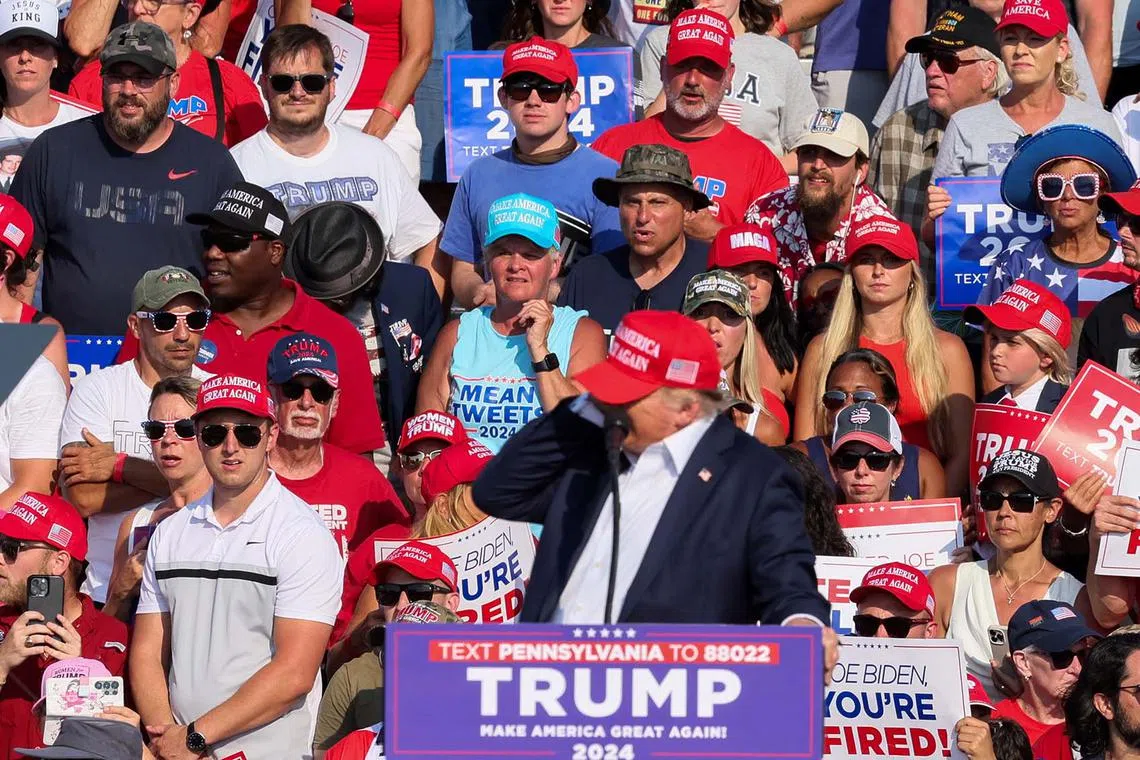 Republican presidential candidate and former U.S. President Donald Trump reacting as multiple shots rang out during the campaign rally.