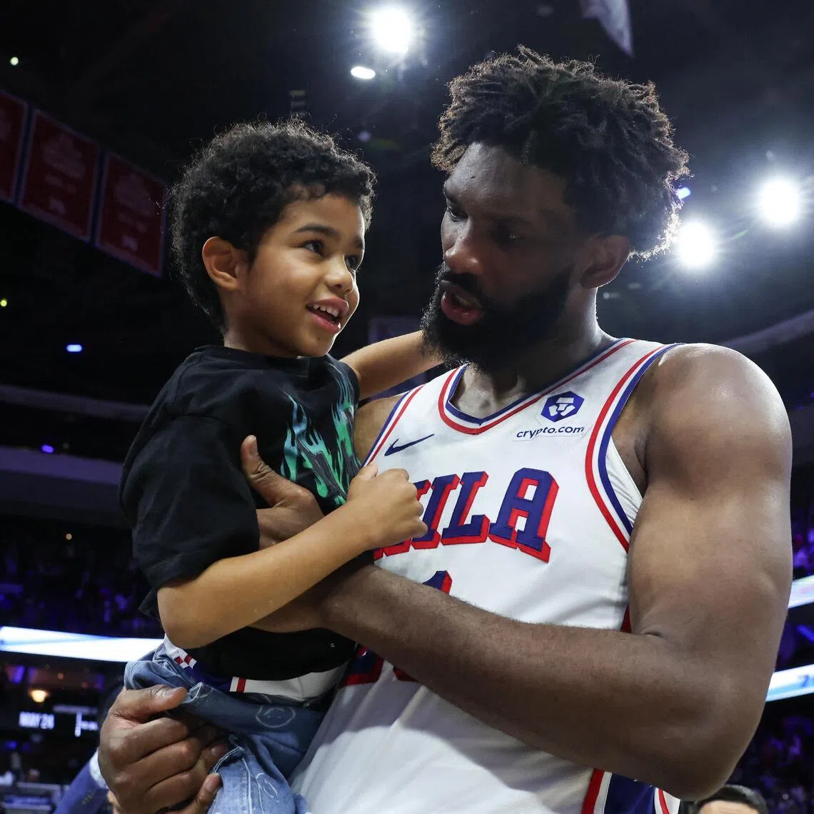 Philadelphia 76ers center Joel Embiid carries his son Arthur on the court after a victory against the Boston Celtics at Xfinity Mobile Arena. 