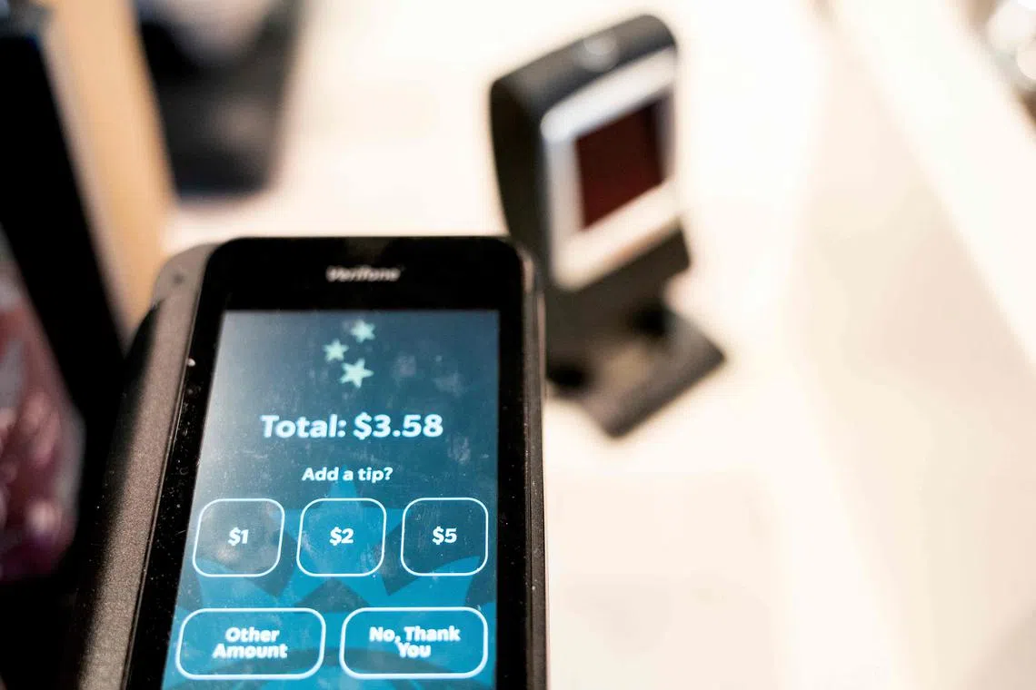 Tip options are displayed on a credit card reader at a store in Washington, DC, on March 17, 2023. - To tip, or not to tip? That is the question many Americans are grappling with in a country where the tip is king -- but even at a grocery store? Or for a bunch of flowers? (Photo by Stefani Reynolds / AFP)