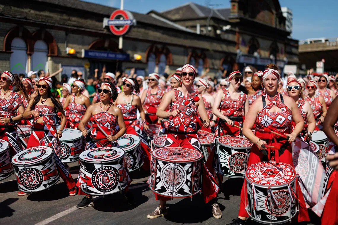 Participants perform during the Notting Hill Carnival parade in London on Aug 25.