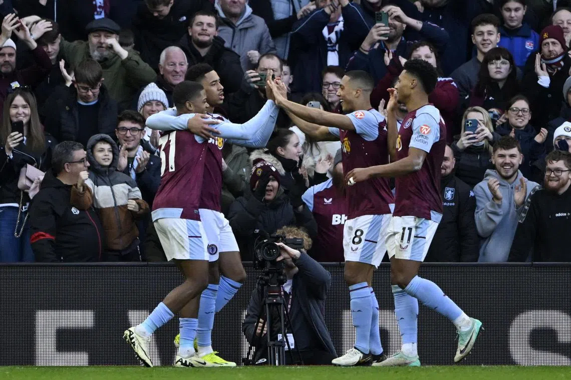 Aston Villa's Leon Bailey celebrates scoring their fourth goal with teammates.