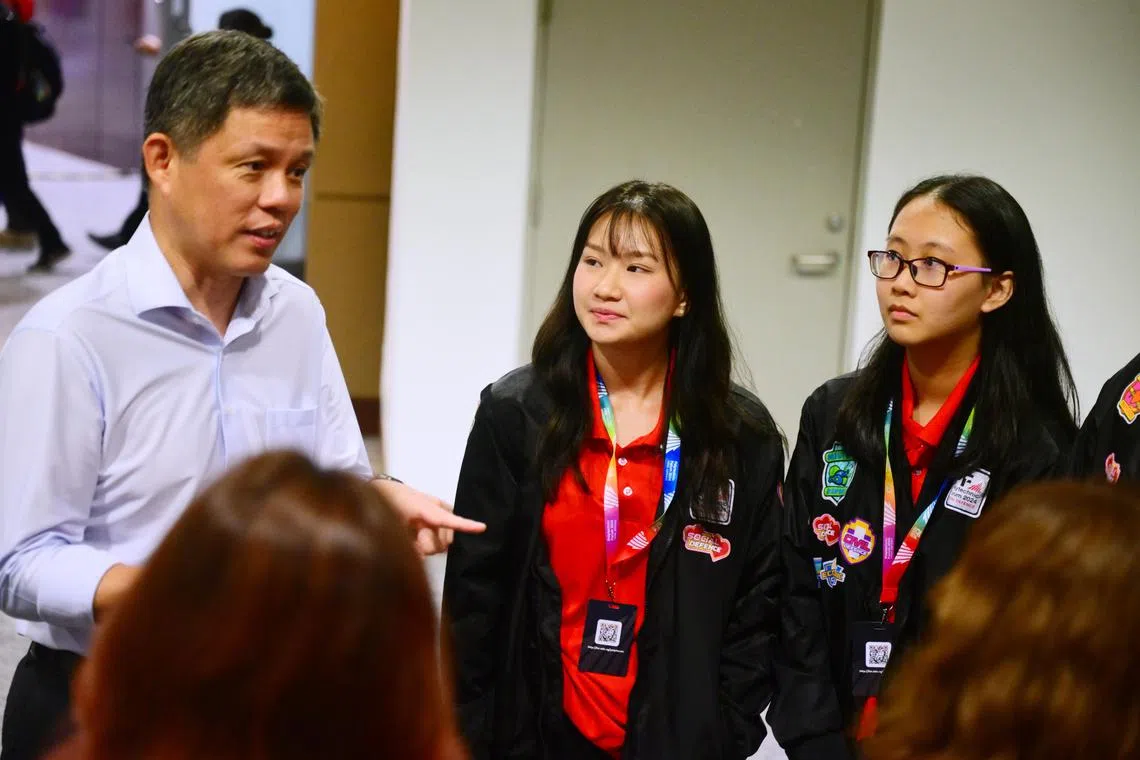 Mr Chan Chun Sing, minister for education, engaging with students (centre) Lencia Wong, 20, Year 3 Pharmaceutical Science student at Nanyang Polytechnic and (right) Fion Ng, 18, Year 2 Information Technology student at Republic Polytechnic, during the Total Defence and Community Engagement at the Forefront of Polytechnic Forum 2024. 

ST PHOTO: AZMI ATHNI