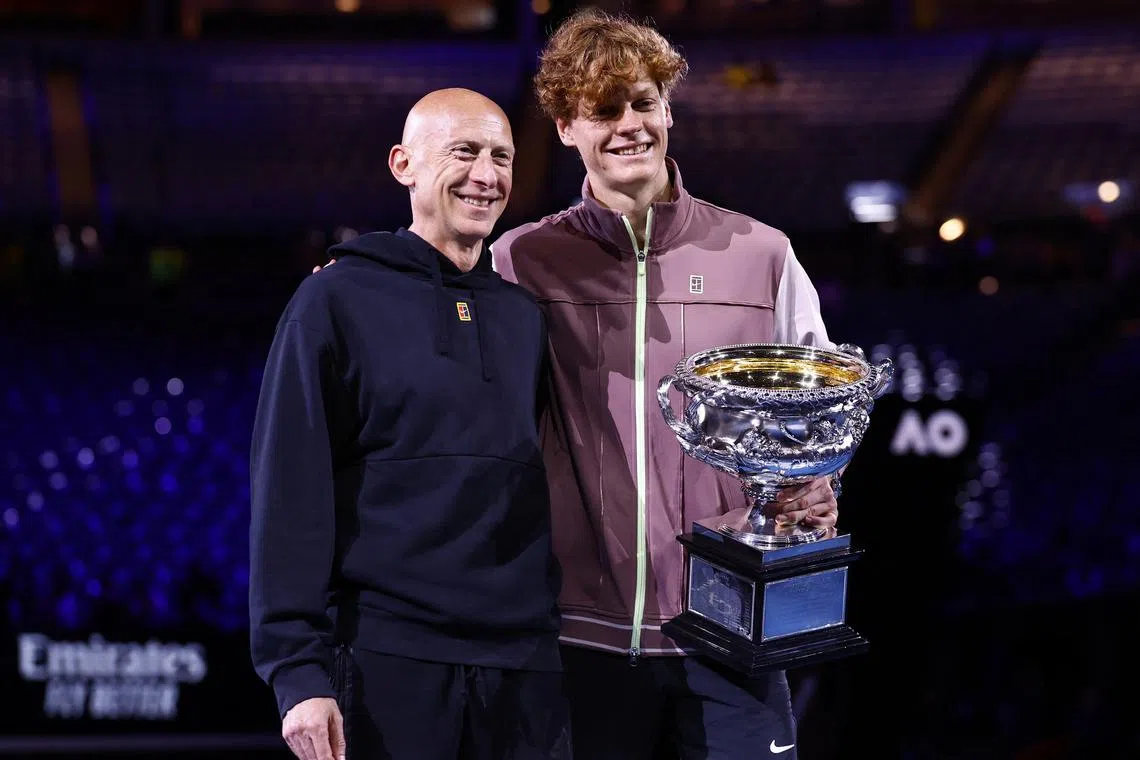 FILE PHOTO: Tennis - Australian Open - Melbourne Park, Melbourne, Australia - January 28, 2024 Italy's Jannik Sinner poses for a picture with the trophy and fitness coach Umberto Ferrara after winning the final against Russia's Daniil Medvedev REUTERS/Issei Kato/File Photo