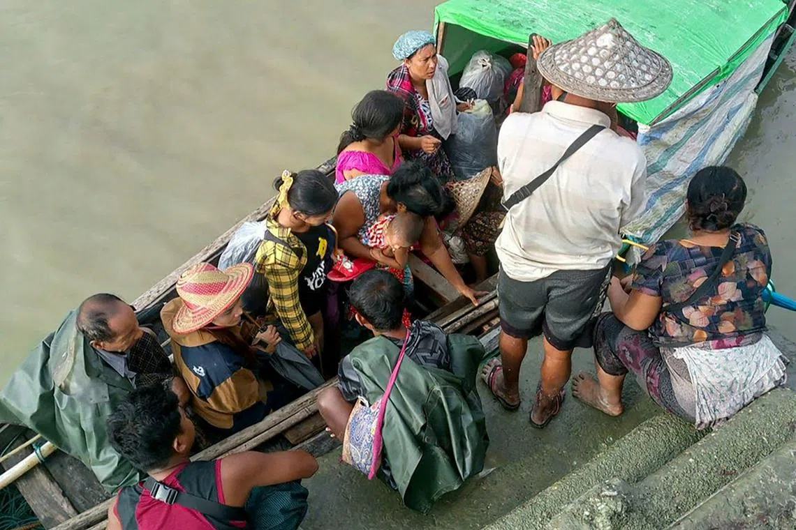People flee from a village after renewed fighting between Myanmar's military and the Arakan Army (AA) in Pauktaw Township on Nov 19, 2023. 
