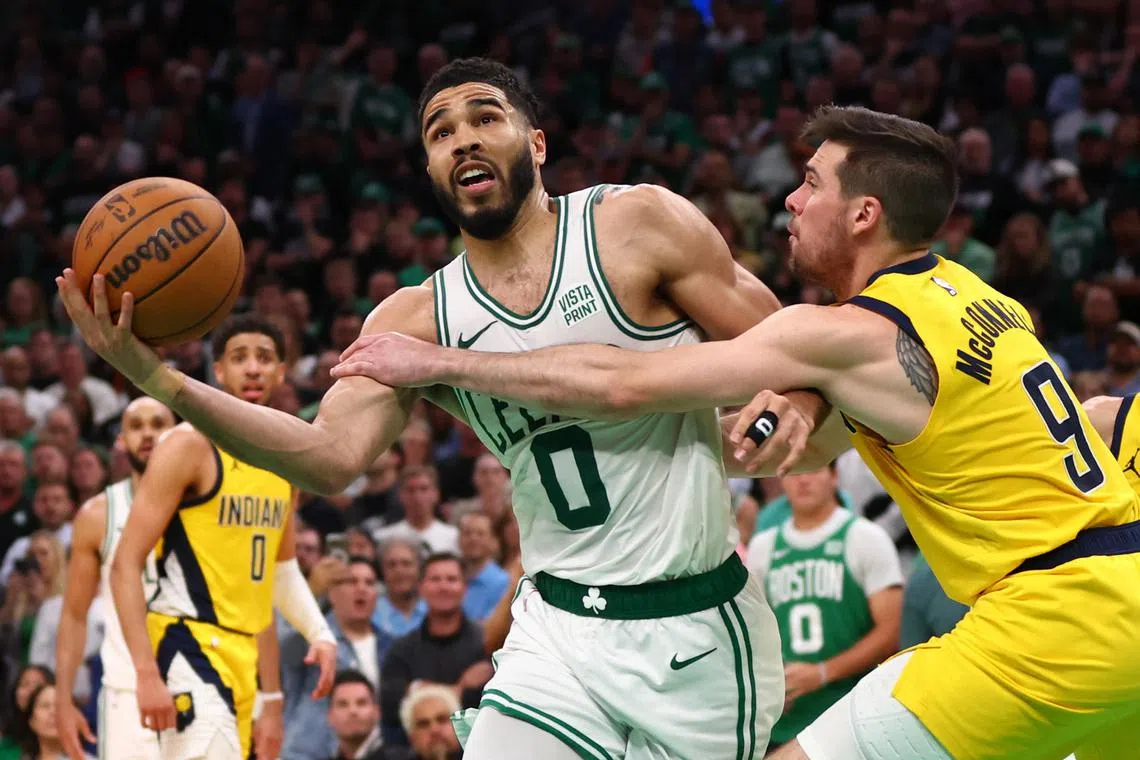 Jayson Tatum of the Boston Celtics is fouled by T.J. McConnell of the Indiana Pacers during overtime in Game 1 of the NBA Eastern Conference Finals.