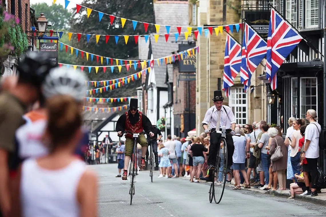Riders are pictured during The Knutsford Great Penny Farthing Bike Race, in Knutsford, Britain on Sept 10, a penny farthing race around the village that takes place every ten years.