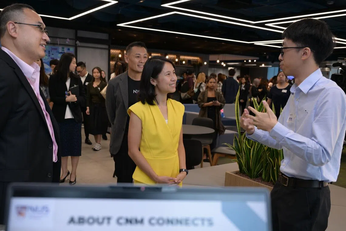Josiah Cheng (left) from NUS, presenting the university?s initiative to bring digital access and digital literacy to disadvantaged groups to senior parliamentary secretary Goh Hanyan at Gen2025 on June 5, 2025.