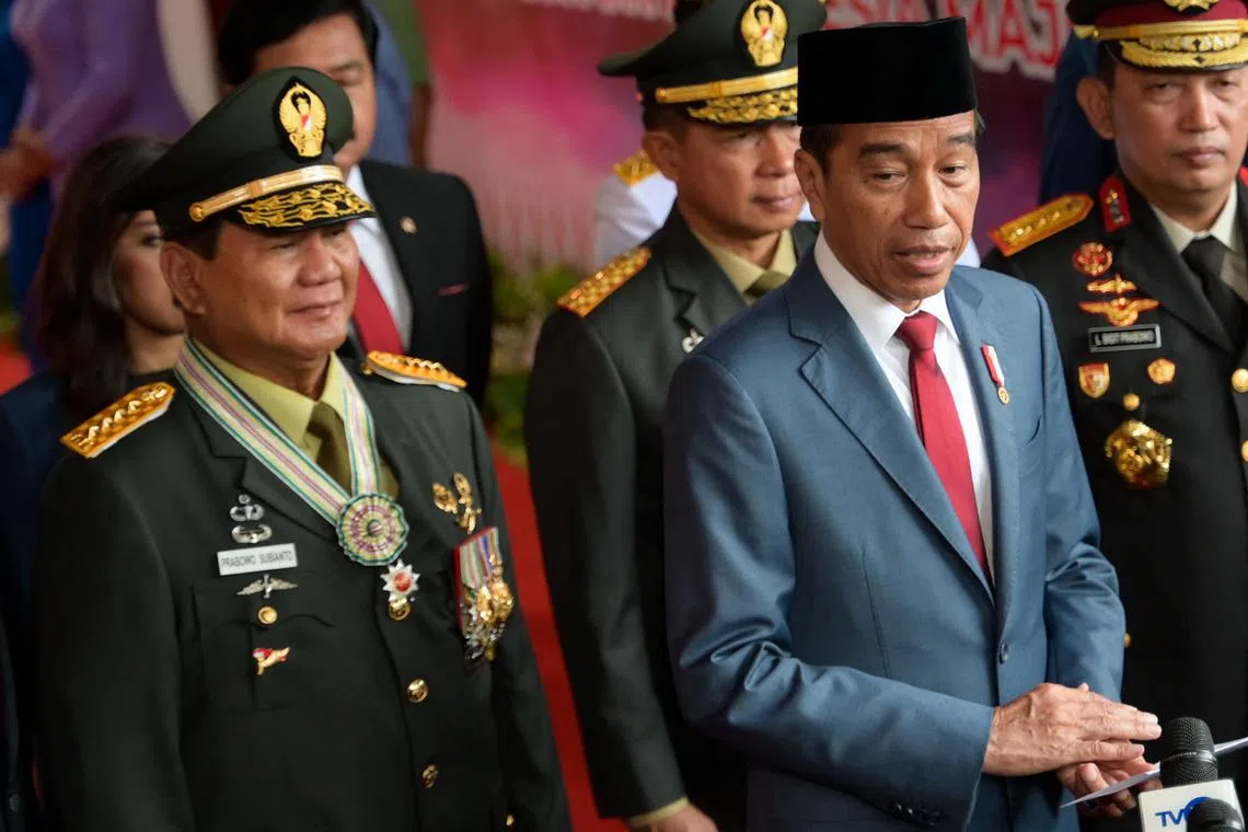 Indonesian President Joko Widodo (right) and incoming President Prabowo Subianto at military headquarters in Jakarta, on Feb 28.