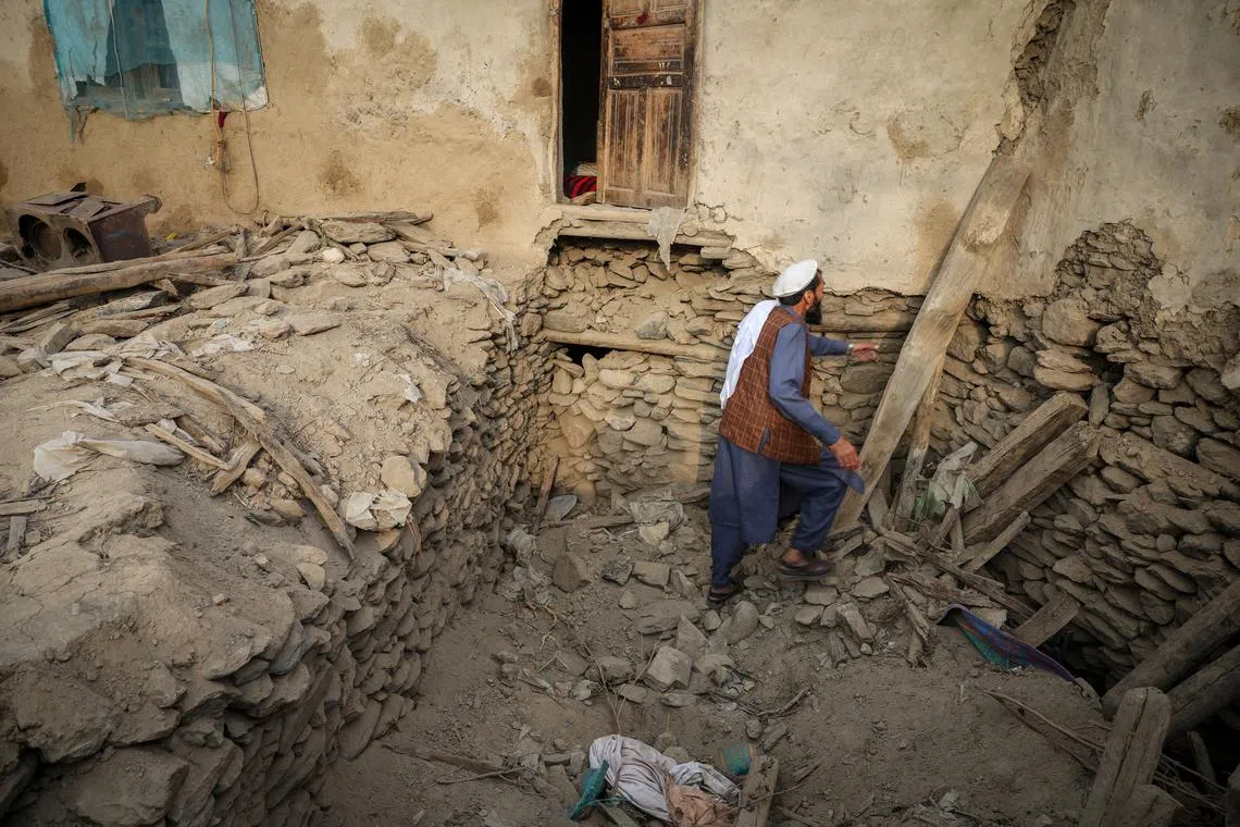 An Afghan man looks for his belongings amidst the rubble of a collapsed house after a deadly magnitude-6 earthquake that struck Afghanistan around midnight, in Dara Noor, in Jalalabad, Afghanistan, September 1, 2025. REUTERS/Sayed Hassib