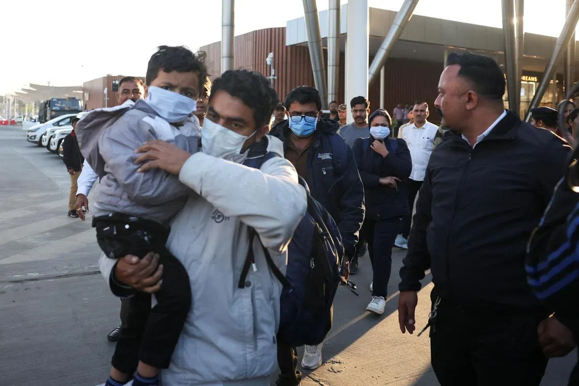 Indian immigrants deported from the U.S., walk out of the airport in Ahmedabad, India February 6, 2025. REUTERS/Amit Dave