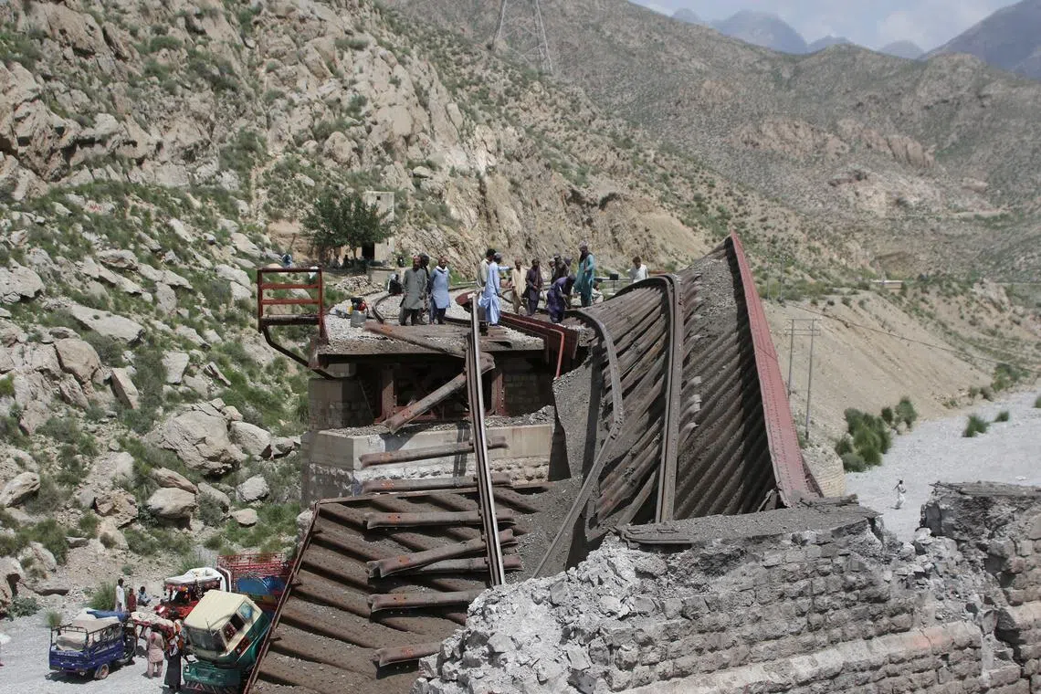 FILE PHOTO: Workers stand on damaged railway tracks as they repair them, a day after separatist militants conducted deadly attacks, in Bolan district of Pakistan's restive province of Balochistan, Pakistan August 27, 2024. REUTERS/Naseer Ahmed/File Photo