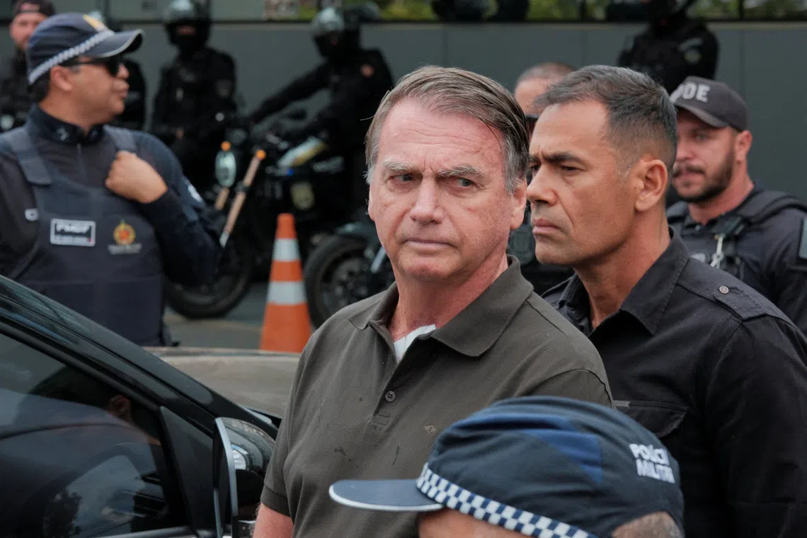 FILE PHOTO: Former Brazilian President Jair Bolsonaro leaves the hospital where he went to undergo a skin surgery procedure, authorized by Supreme Court Justice Alexandre de Moraes, leaving the house arrest after being convicted by a Supreme Court majority of plotting a coup to remain in power after losing the 2022 election, in Brasilia, Brazil, September 14, 2025. REUTERS/Diego Herculano/ File Photo