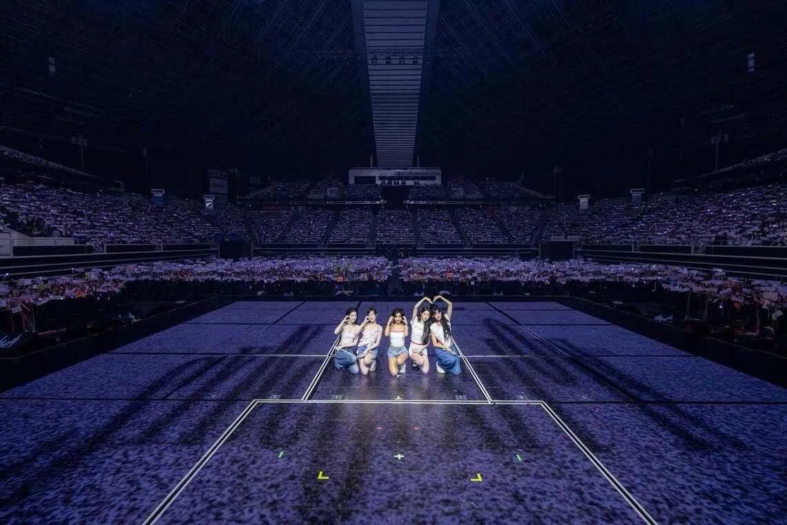 South Korean girl group I-dle, consisting (from left) Shuhua, Yuqi, Soyeon, Miyeon and Minnie taking a photo with fans during their concert at the Singapore Indoor Stadium on June 13.