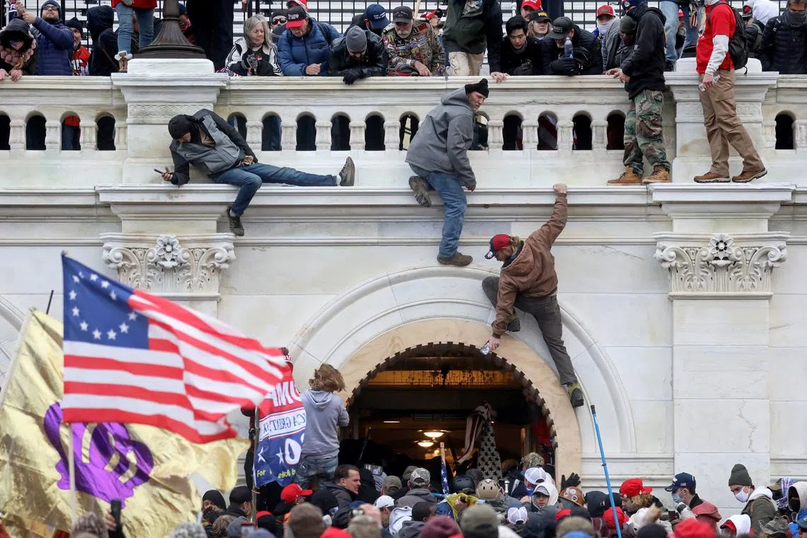 FILE PHOTO: A mob of supporters of U.S. President Donald Trump fight with members of law enforcement at a door they broke open as they storm the U.S. Capitol Building in Washington, U.S., January 6, 2021.  REUTERS/Leah Millis/File Photo