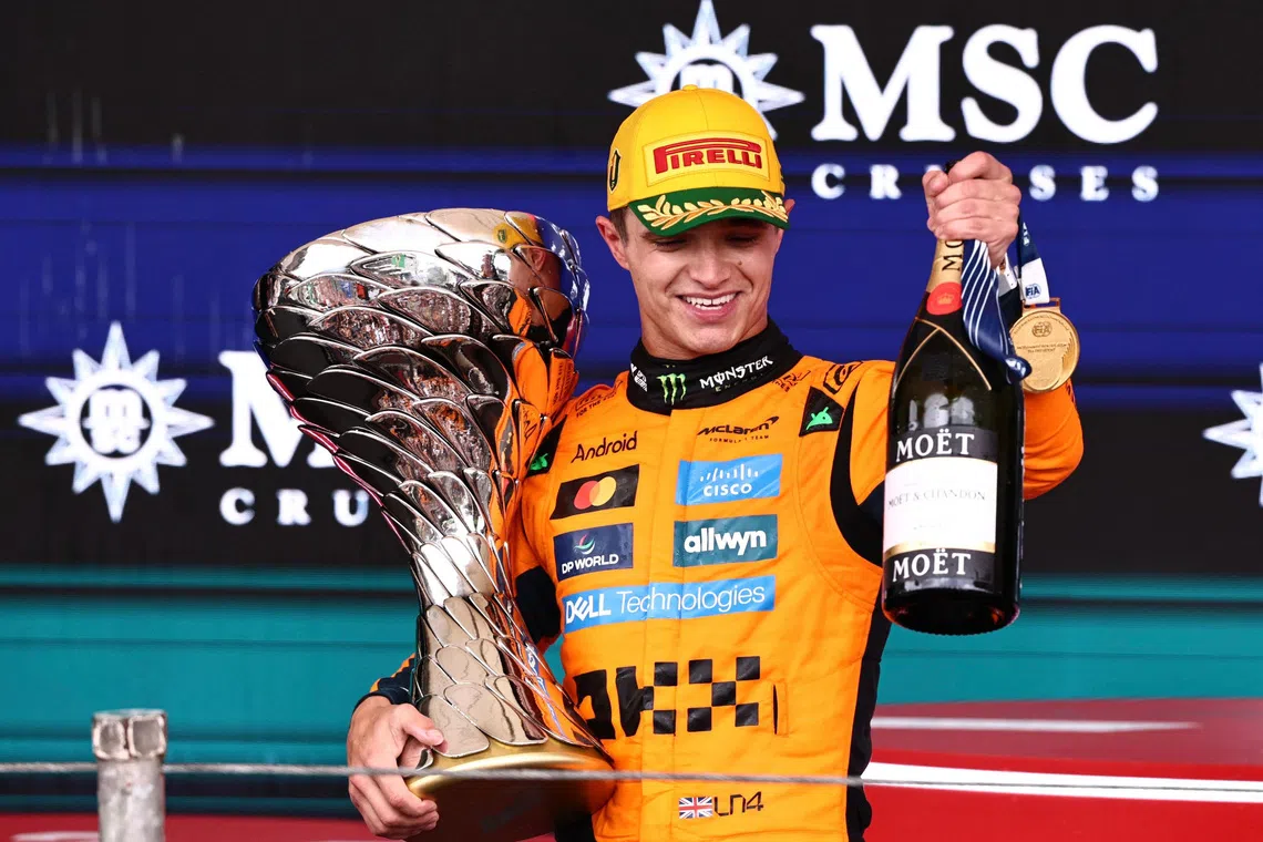 Formula One F1 - Sao Paulo Grand Prix - Autodromo Jose Carlos Pace, Sao Paulo, Brazil - November 9, 2025 McLaren's Lando Norris celebrates on the podium with a trophy after winning the Sao Paulo Grand Prix REUTERS/Jean Carniel