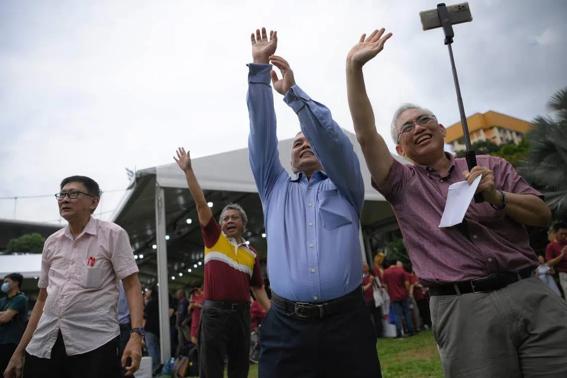 Supporters cheering while Tan Kin Lian makes his speech.