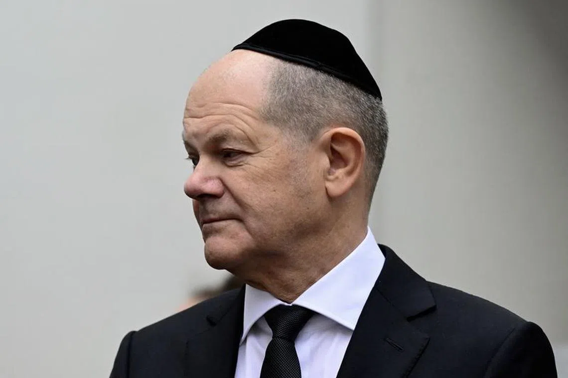 German Chancellor Olaf Scholz wears a kippah as he arrives to attend a central commemoration ceremony for the 85th anniversary of the Night of Broken Glass (Kristallnacht) taking place in the Beth Zion Synagogue in Berlin, Germany, on November 9, 2023.     JOHN MACDOUGALL/Pool via REUTERS