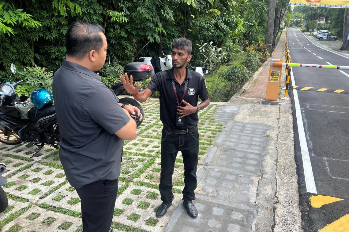 An executive council member of the Union of Security Employees (left) visiting the security officer, identified as Brother Chandra.