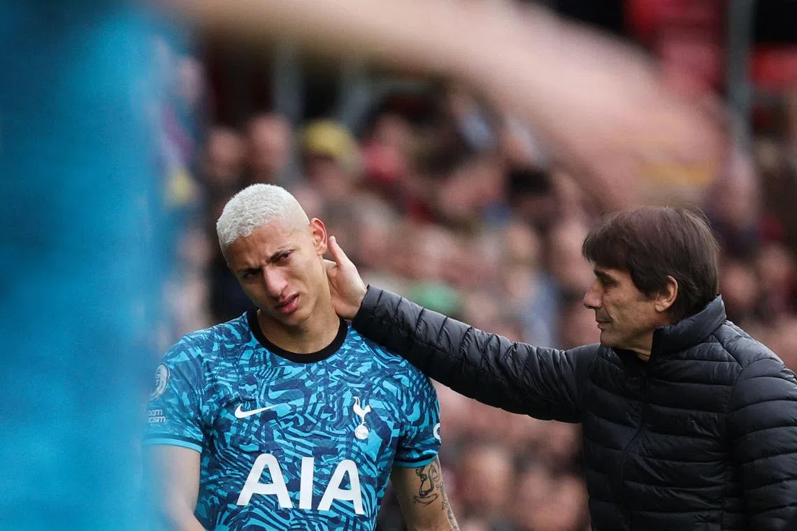 Tottenham Hotspur's Brazilian striker Richarlison is comforted by coach Antonio Conte as he leaves the pitch, during the match against Southampton.