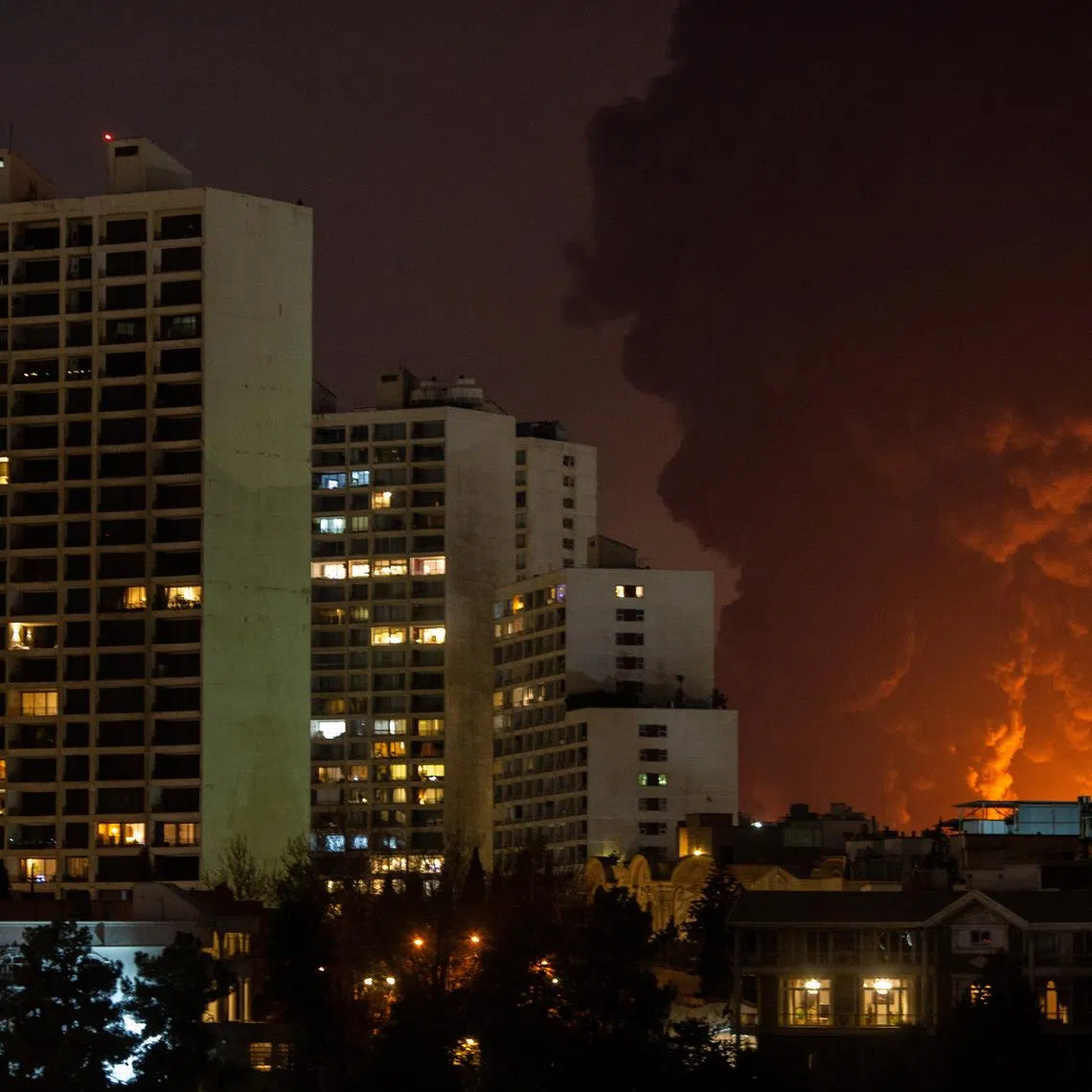 Smoke billows from fuel storage and energy complexes after US-Israeli air strikes in Tehran on March 7. US and Israeli strikes have hit tens of thousands of civilian sites in Iran, said officials.