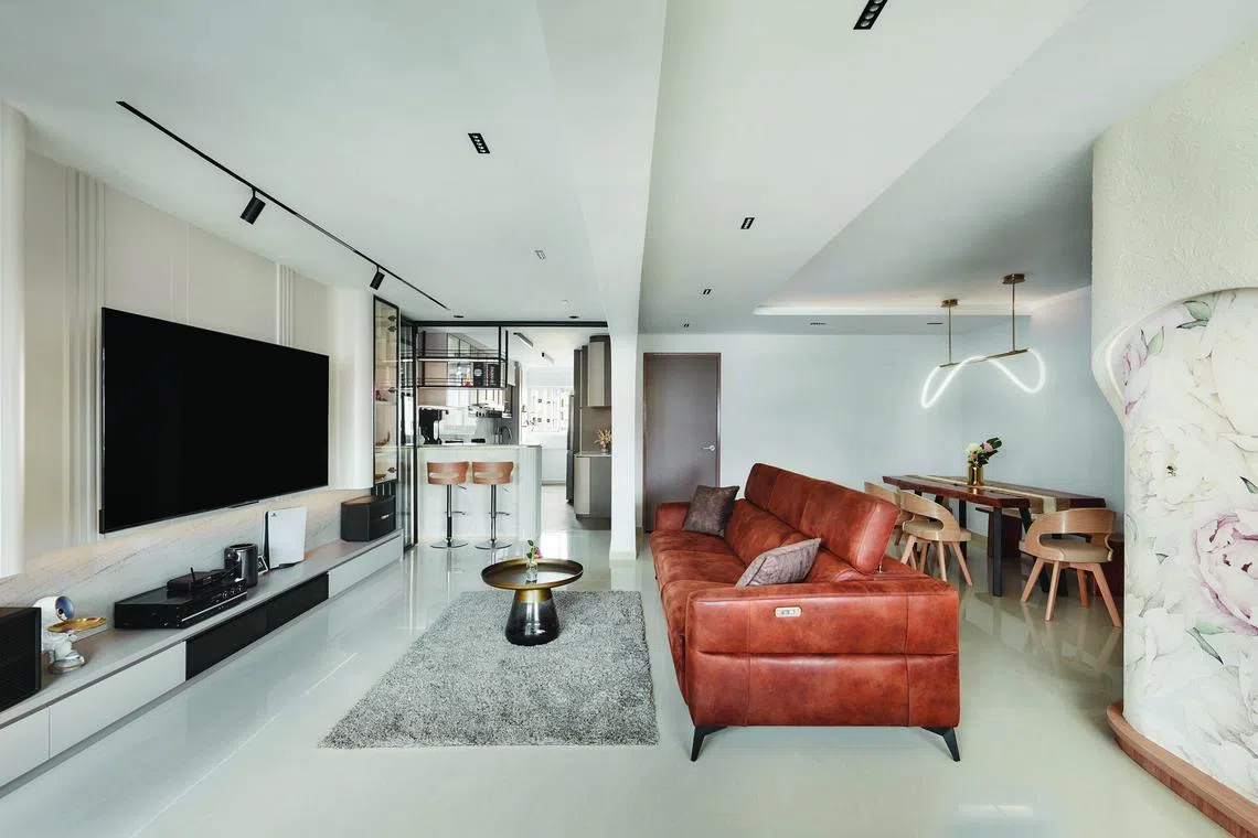 From the feature wall to the dining area light, elegant curves can be found throughout this five-room flat in Tampines.