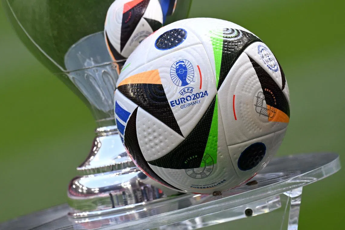 Soccer Football - Euro 2024 - Trophy Display at Allianz Arena, Munich, Germany - May 13, 2024 General view of the Fussballliebe match ball on display next to the European Championship trophy during the presentation REUTERS/Angelika Warmuth