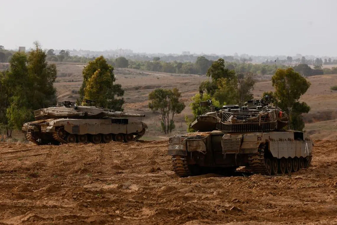 Israeli tanks take position near a border with Gaza, amid the ongoing conflict between Israel and the Palestinian group Hamas, November 22, 2023. REUTERS/Amir Cohen